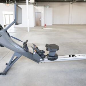 Aviron rower standing alone in a home gym.