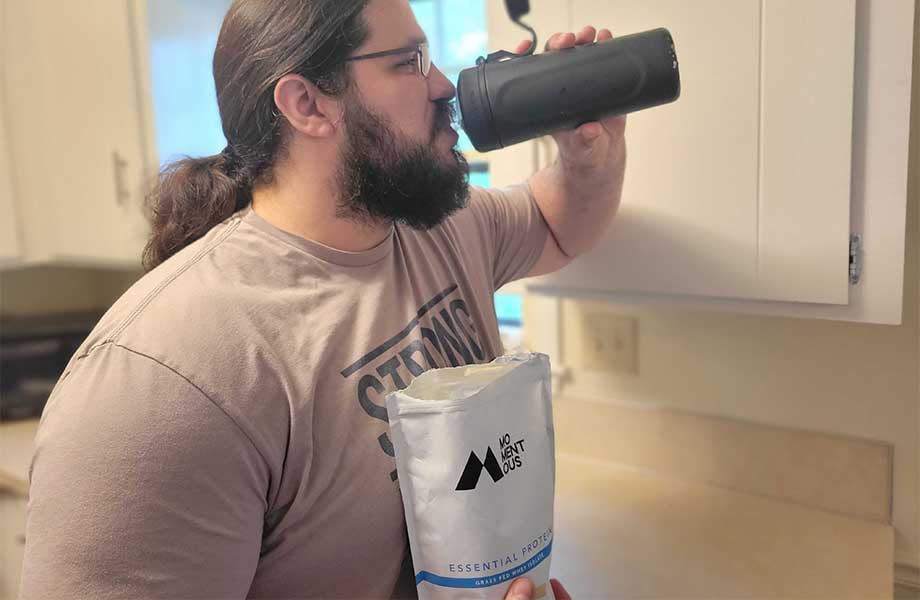 man drinking and testing the momentous whey protein powder