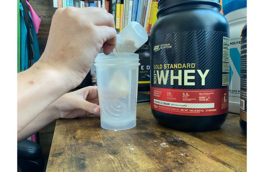 optimum nutrition whey protein powder in a shaker bottle