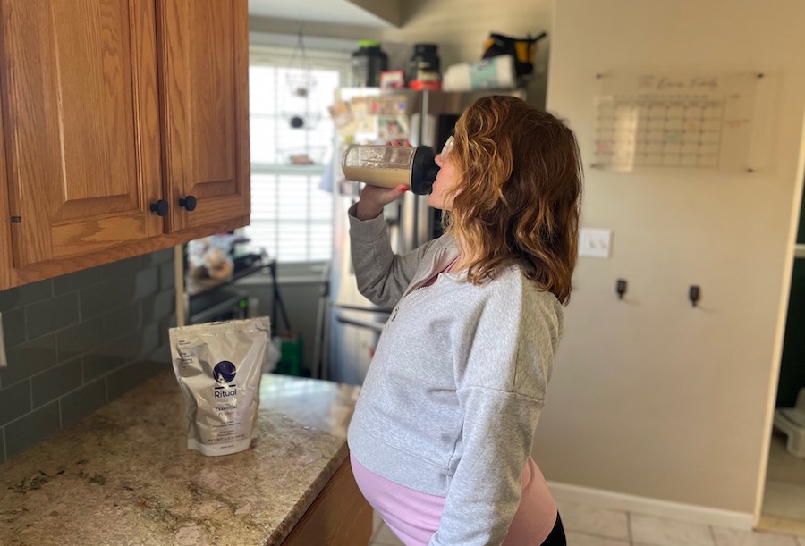 woman drinking Ritual Essential protein powder for pregnancy